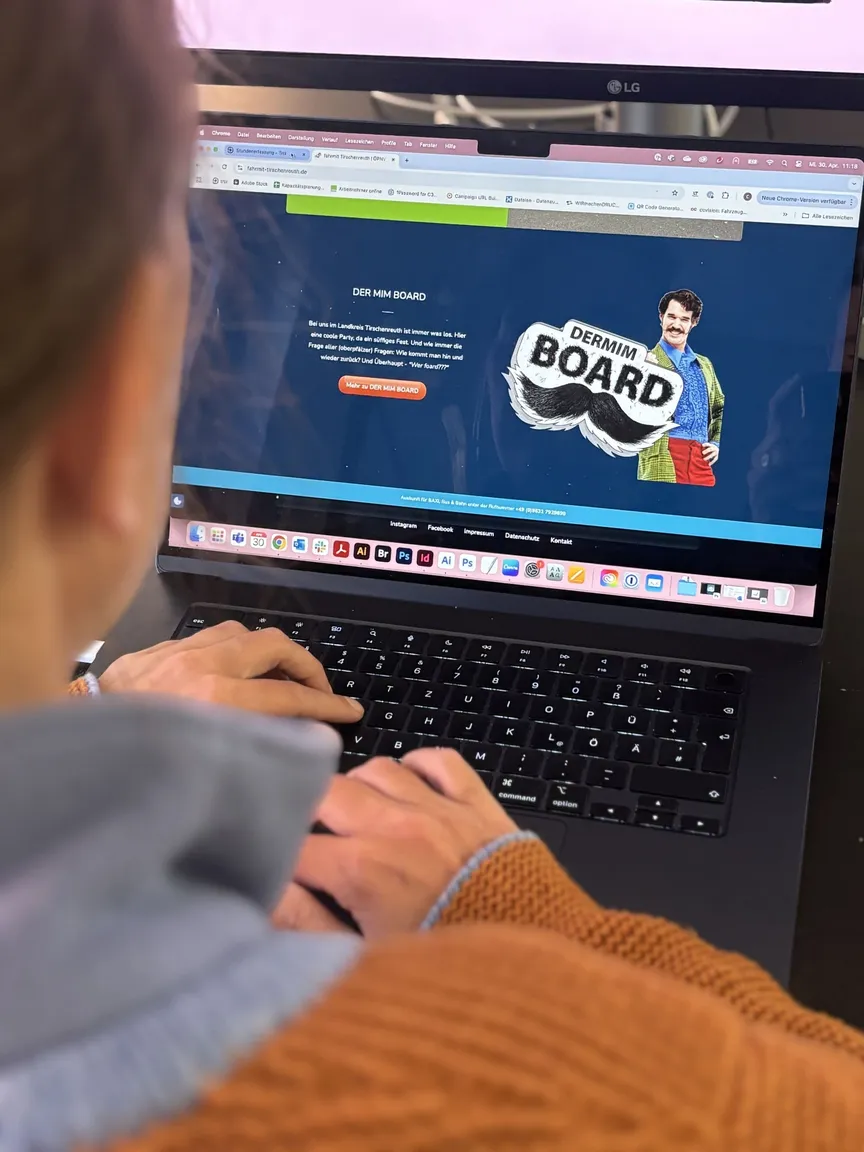 Person am Laptop mit geöffneter Website der Mobilitätskampagne „DER MIM BOARD“ des Landkreises Tirschenreuth
